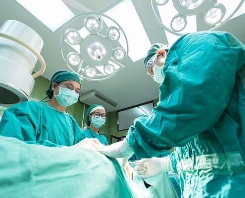 Who pays for surgery after a car accident in Lake City, Florida?